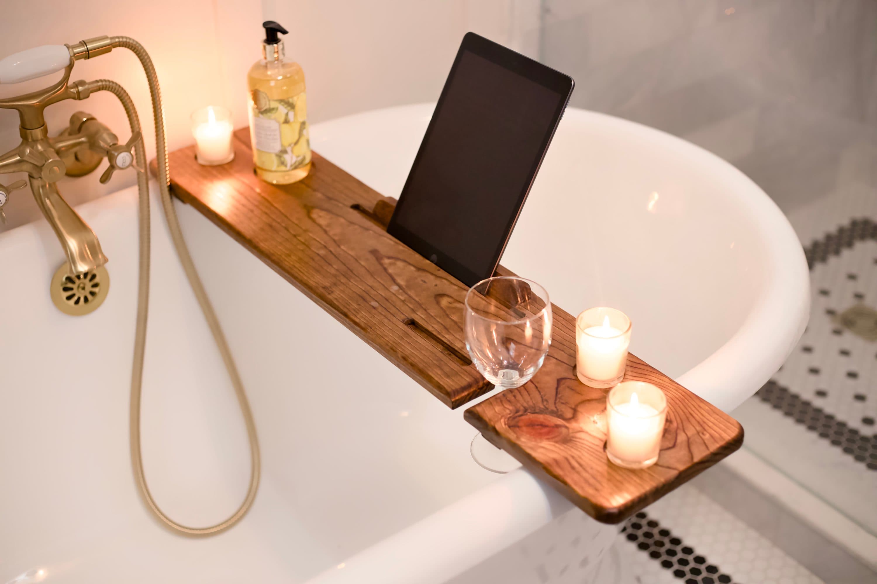 Bathtub tray holding a tablet and candles